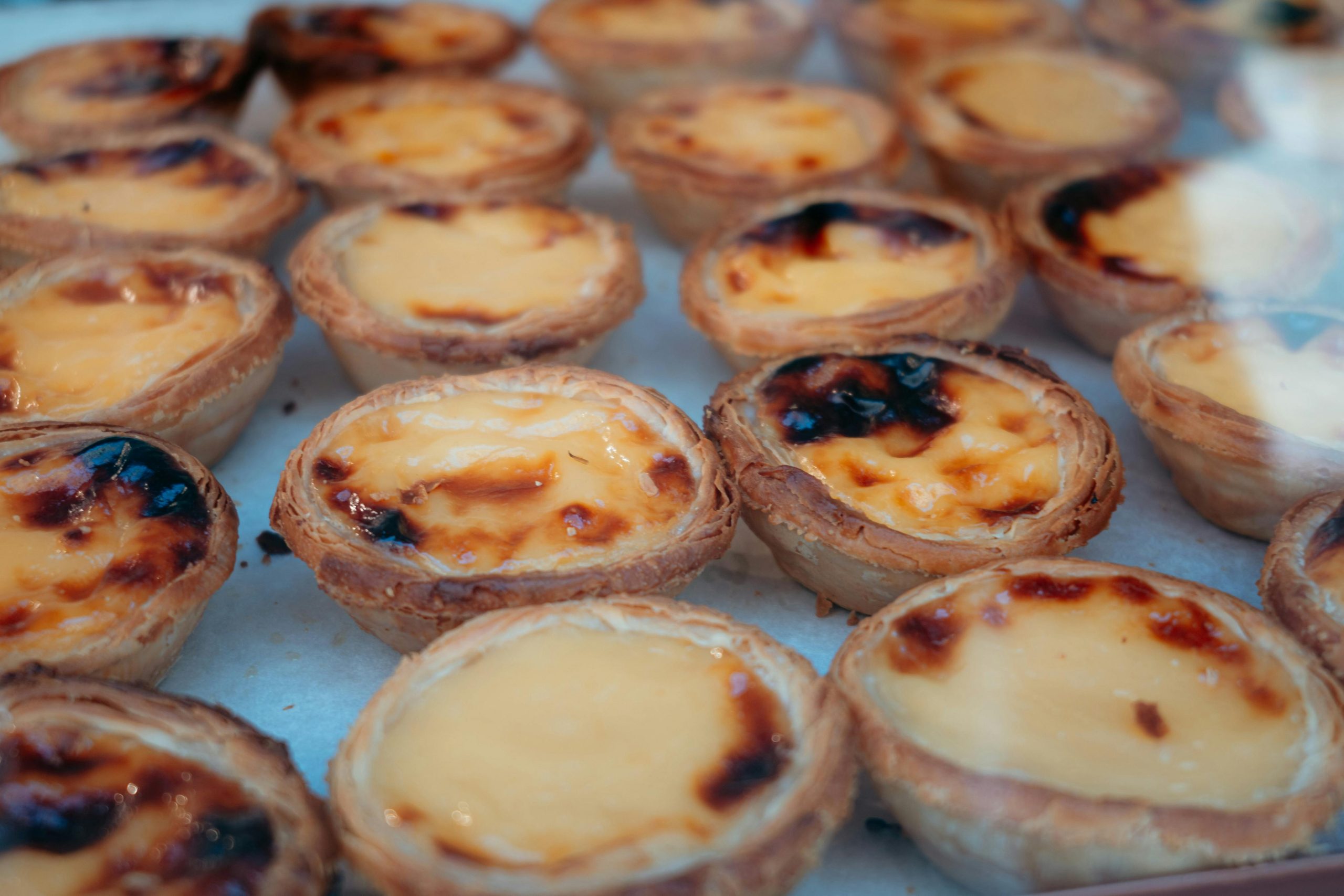 Close-up of delicious Portuguese custard tarts, perfect for dessert lovers.